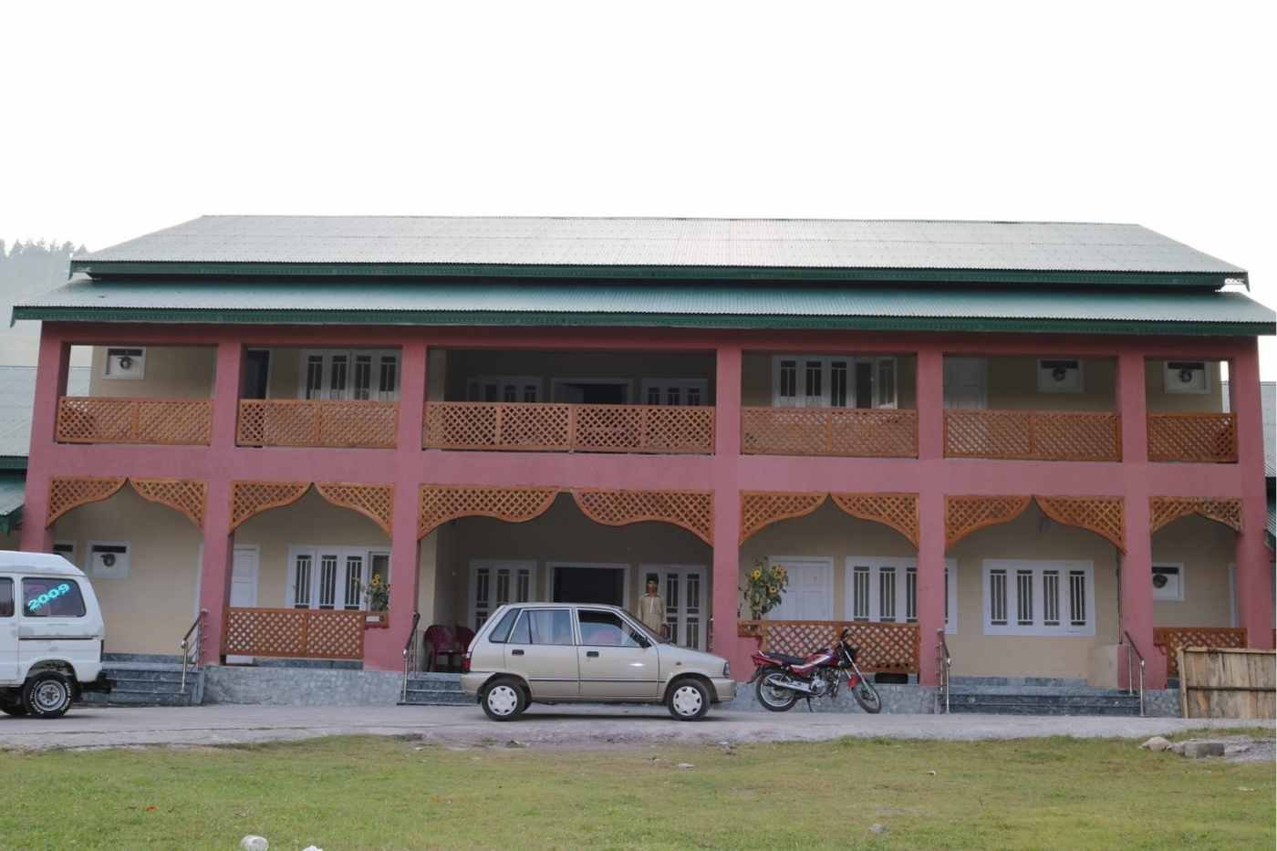 AJK Tourism Department guest house building with parked vehicles in Neelum Valley