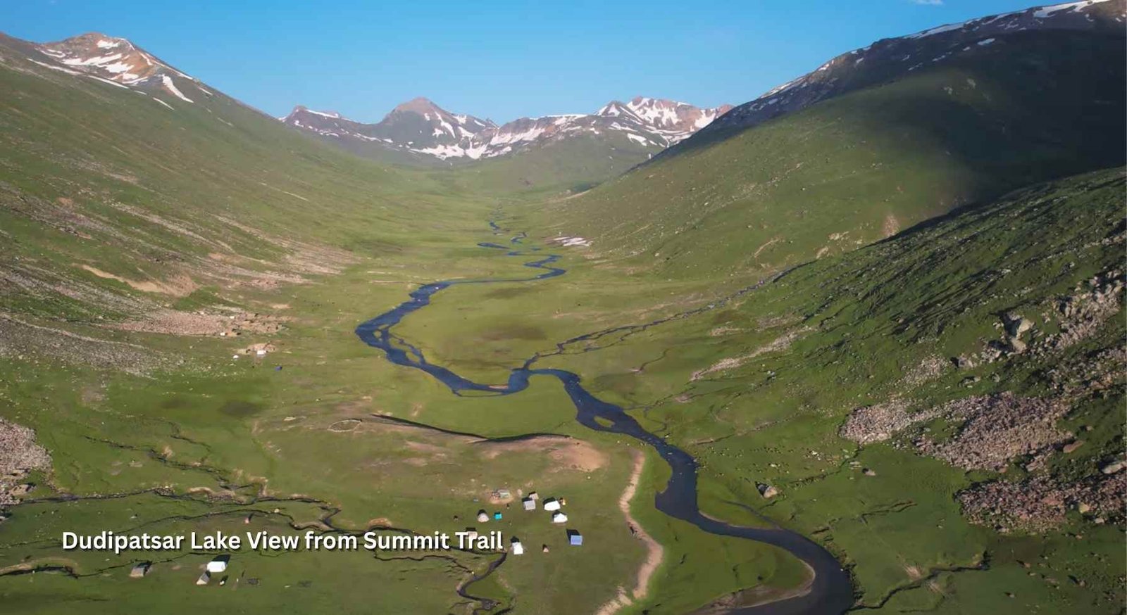Scenic view of Dudipatsar Lake with turquoise waters surrounded by snow-capped peaks in Pakistan’s Kaghan Valley