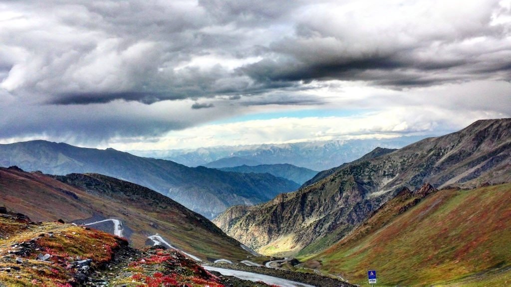 Travelers at Babusar Top with panoramic mountain views