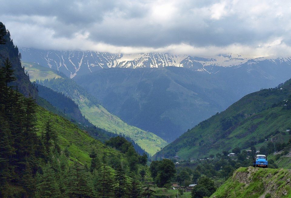 Green Dher meadows with tents set up on the Manoor Valley route to Ansoo Jheel Pakistan