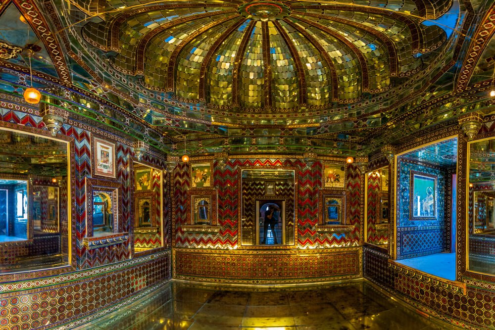 Sheesh Mahal at Lahore Fort illuminated during the History by Night tour with visitors exploring the palace of mirrors.