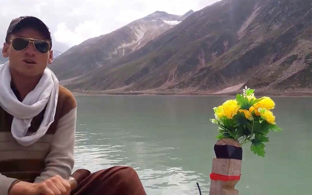 Tourists enjoying a rowing boat ride on the turquoise waters of Jheel Saif ul Malook