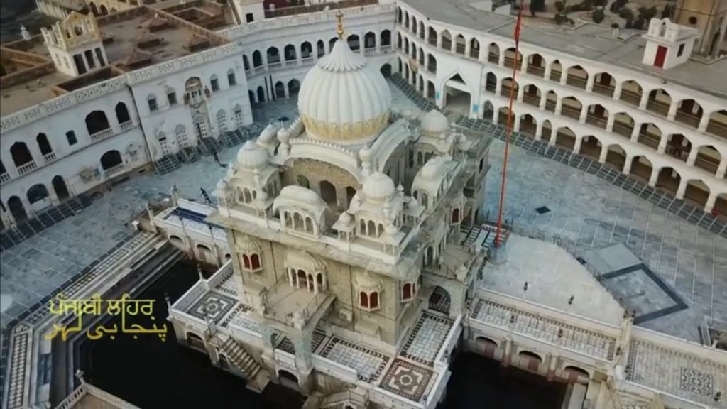 Drone view of Panja Sahib Hasan Abdal gurdwara, featuring the main dome, sarovar, and surrounding courtyard in Attock District, Pakistan.