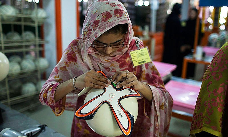Workers stitching footballs in Sialkot, Pakistan—the city that produces 70% of the world’s soccer balls